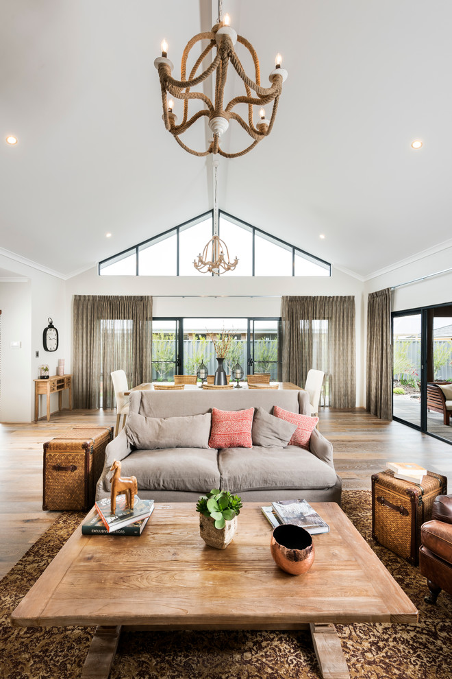 This is an example of a large transitional open concept living room in Perth with grey walls and vinyl floors.