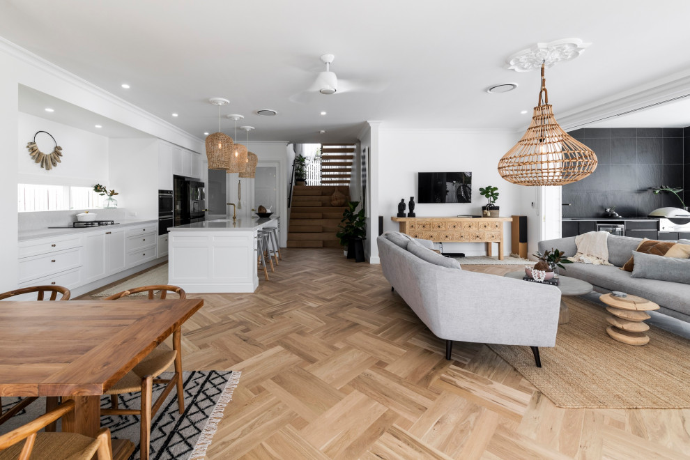 Photo of a large beach style open concept living room with light hardwood floors.