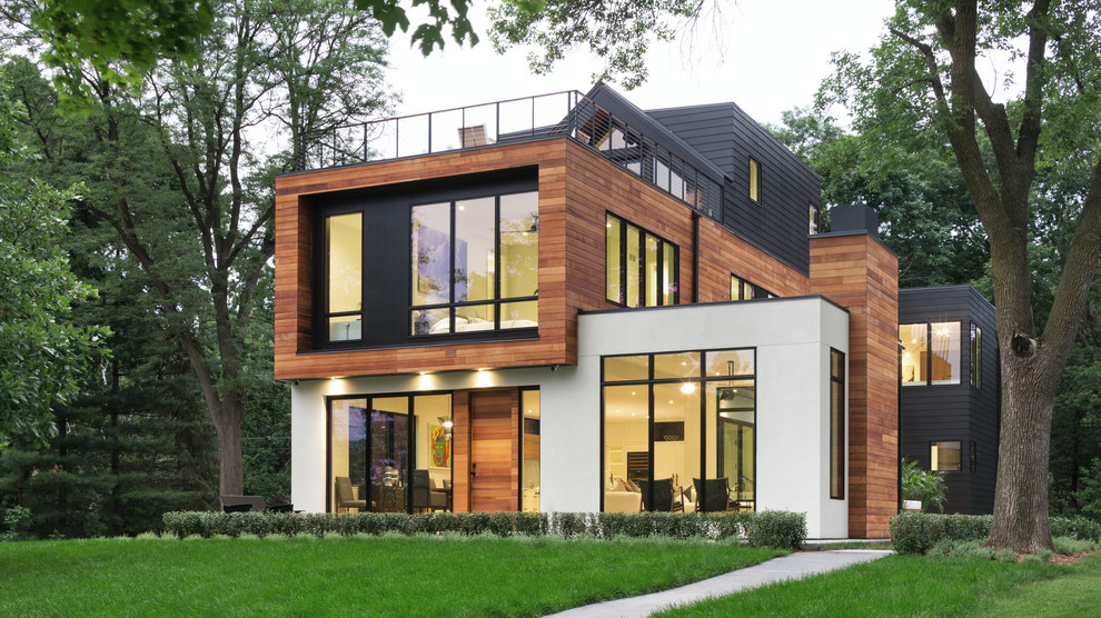 Design ideas for a contemporary three-storey multi-coloured house exterior in Minneapolis with mixed siding and a flat roof.