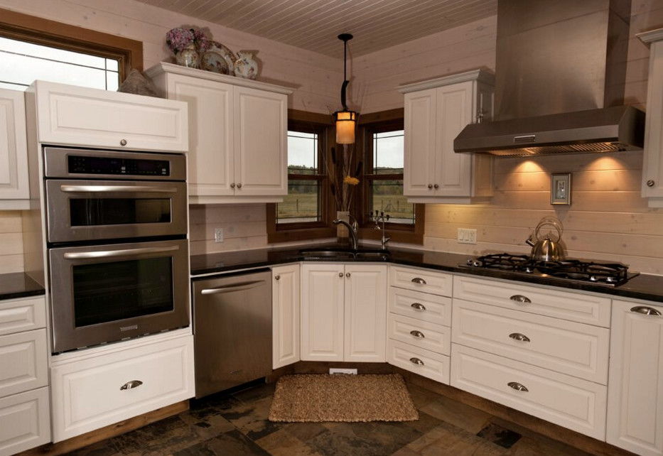 Open concept kitchen - large rustic galley dark wood floor open concept kitchen idea in Boston with an undermount sink, shaker cabinets, white cabinets, granite countertops, stainless steel appliances and an island