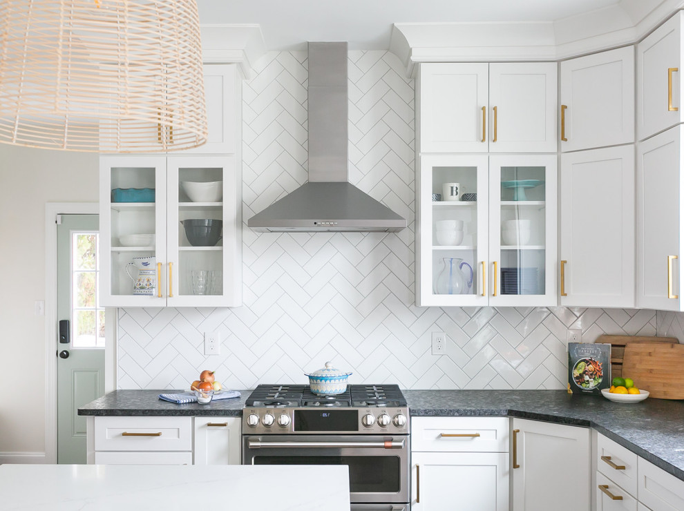 Inspiration for a large transitional l-shaped brown floor kitchen pantry remodel in Baltimore with a drop-in sink, shaker cabinets, white cabinets, quartz countertops, white backsplash, ceramic backsplash, stainless steel appliances, an island and white countertops