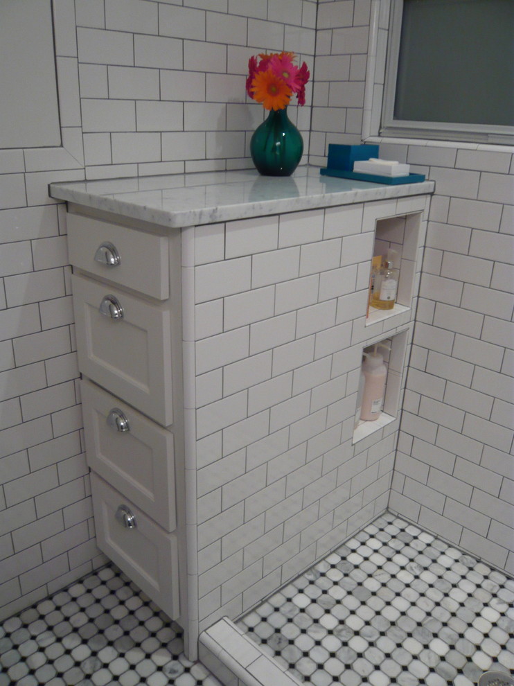 This is an example of a small traditional 3/4 bathroom in Dallas with a pedestal sink, shaker cabinets, white cabinets, marble benchtops, an open shower, a two-piece toilet, white tile, subway tile, white walls and marble floors.