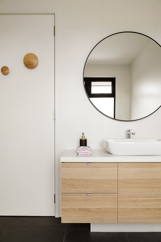 Design ideas for a scandinavian master bathroom in Melbourne with flat-panel cabinets, light wood cabinets, a freestanding tub, a corner shower, white walls, porcelain floors, a vessel sink and engineered quartz benchtops.