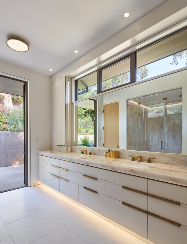 Photo of a contemporary master bathroom in San Francisco with flat-panel cabinets, white cabinets, an alcove shower, white walls, an undermount sink, marble benchtops, a hinged shower door, multi-coloured benchtops, a double vanity, white floor and a built-in vanity.