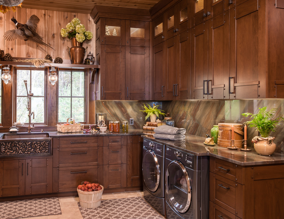 Inspiration for a large traditional l-shaped dedicated laundry room in Other with a farmhouse sink, beige floor, recessed-panel cabinets, onyx benchtops, beige walls, porcelain floors, a side-by-side washer and dryer, brown benchtop and dark wood cabinets.