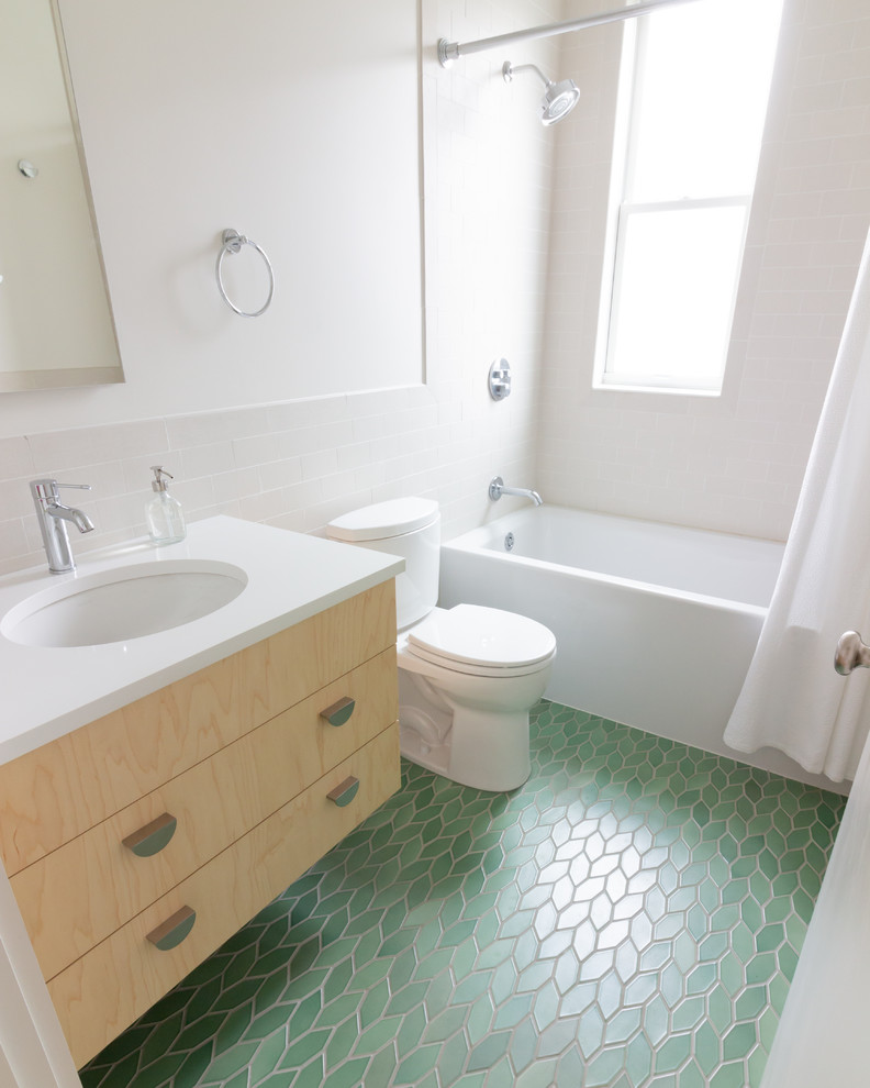 Design ideas for a scandinavian 3/4 bathroom in Boston with flat-panel cabinets, light wood cabinets, an alcove tub, a shower/bathtub combo, a two-piece toilet, beige tile, porcelain tile, white walls, ceramic floors, an undermount sink, engineered quartz benchtops, green floor, a shower curtain and white benchtops.
