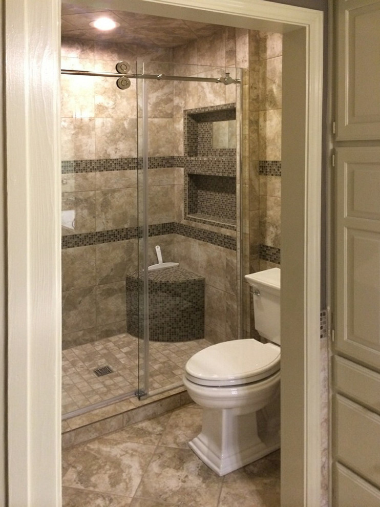 This is an example of a small traditional 3/4 bathroom in Austin with raised-panel cabinets, beige cabinets, an alcove shower, a two-piece toilet, gray tile, white tile, glass tile, grey walls, ceramic floors, an integrated sink, engineered quartz benchtops, grey floor, a sliding shower screen and white benchtops.