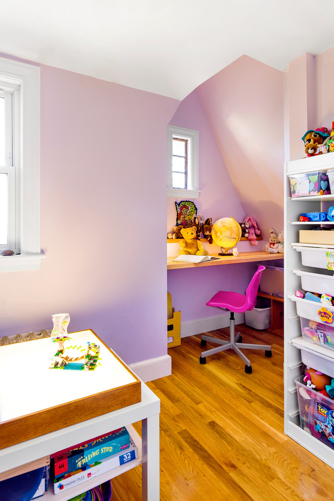 Photo of a mid-sized eclectic kids' playroom for kids 4-10 years old and girls in Boston with purple walls, light hardwood floors and beige floor.