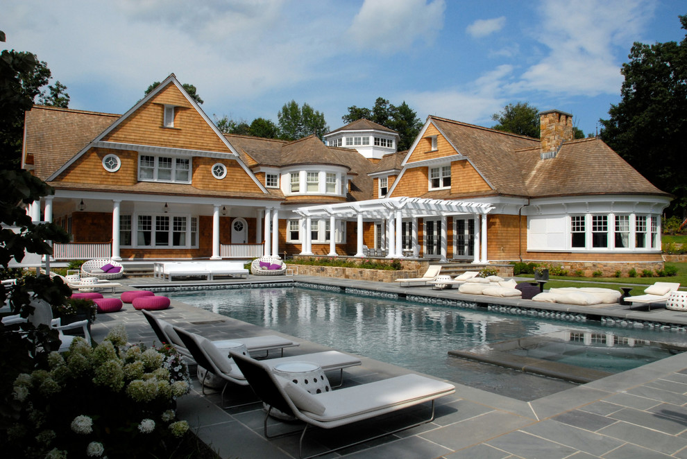 Design ideas for a beach style pool in New York with natural stone pavers.