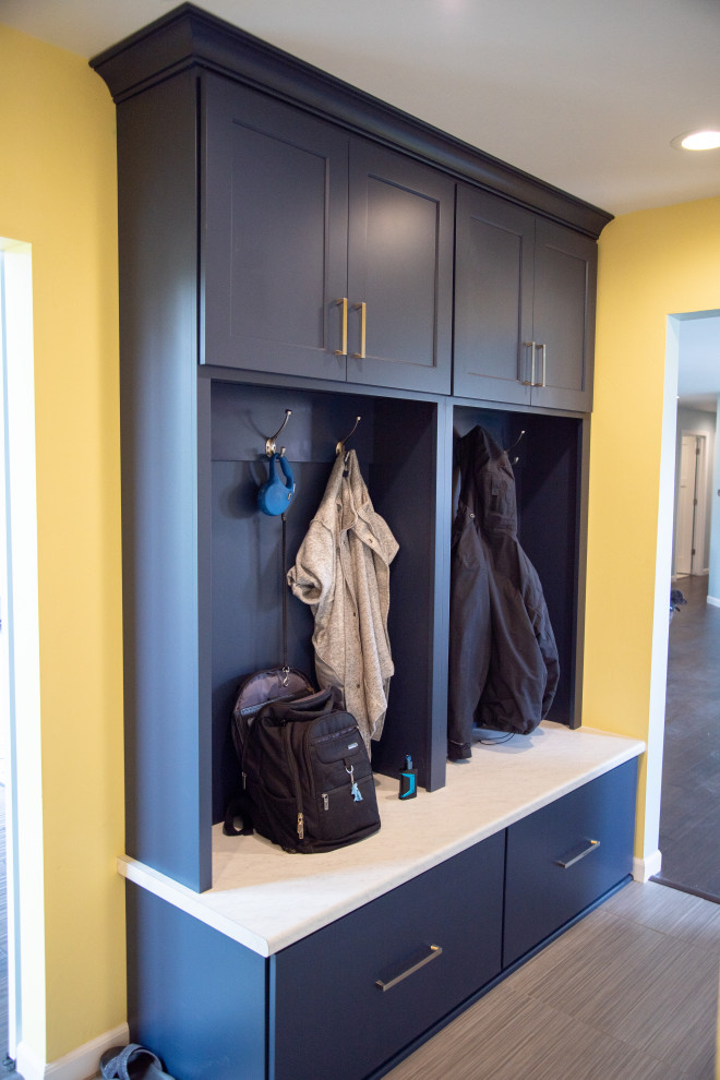 Inspiration for a mid-sized modern mudroom in Other with yellow walls, vinyl floors, a double front door, a white front door and grey floor.