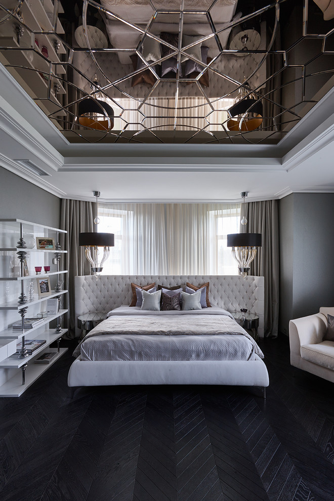 This is an example of a transitional bedroom in Moscow with grey walls, dark hardwood floors and black floor.