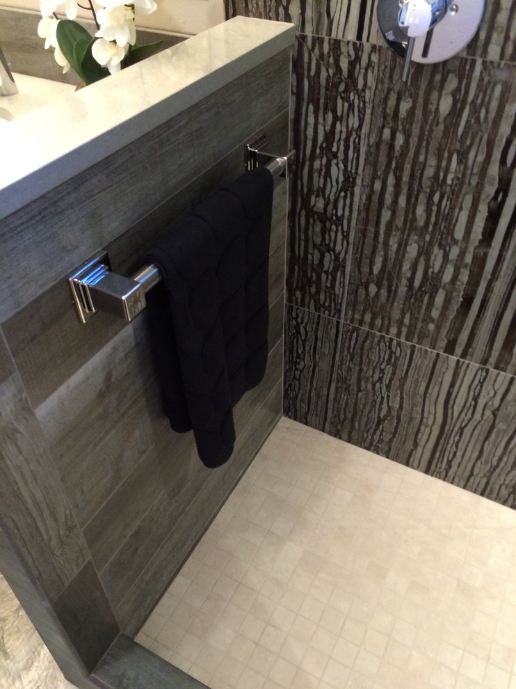 This is an example of a small contemporary master bathroom in Seattle with flat-panel cabinets, dark wood cabinets, an open shower, a one-piece toilet, gray tile, stone tile, grey walls, mosaic tile floors, an undermount sink and engineered quartz benchtops.