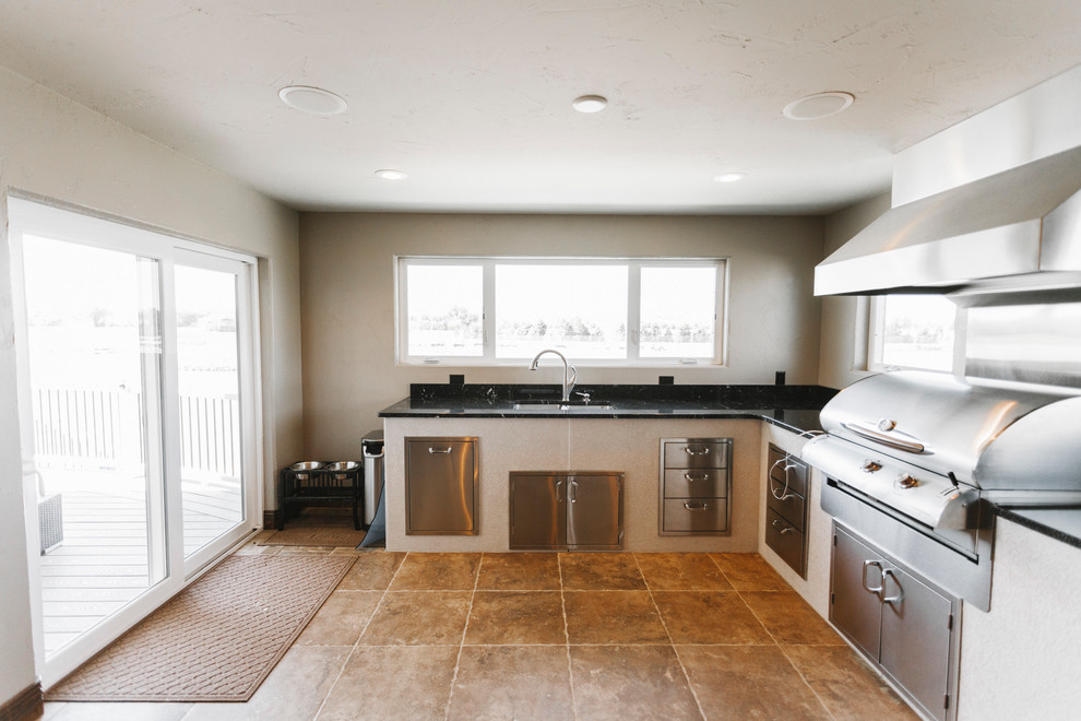 Inspiration for a transitional slate floor kitchen remodel with a double-bowl sink, granite countertops, stainless steel appliances and beige walls