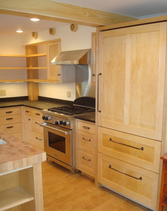 Inspiration for a mid-sized l-shaped medium tone wood floor eat-in kitchen remodel with medium tone wood cabinets, solid surface countertops, stainless steel appliances and an island