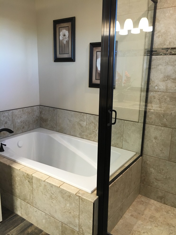 Example of a mid-sized transitional master beige tile and porcelain tile porcelain tile drop-in bathtub design with raised-panel cabinets, dark wood cabinets, a two-piece toilet, beige walls, an undermount sink and granite countertops