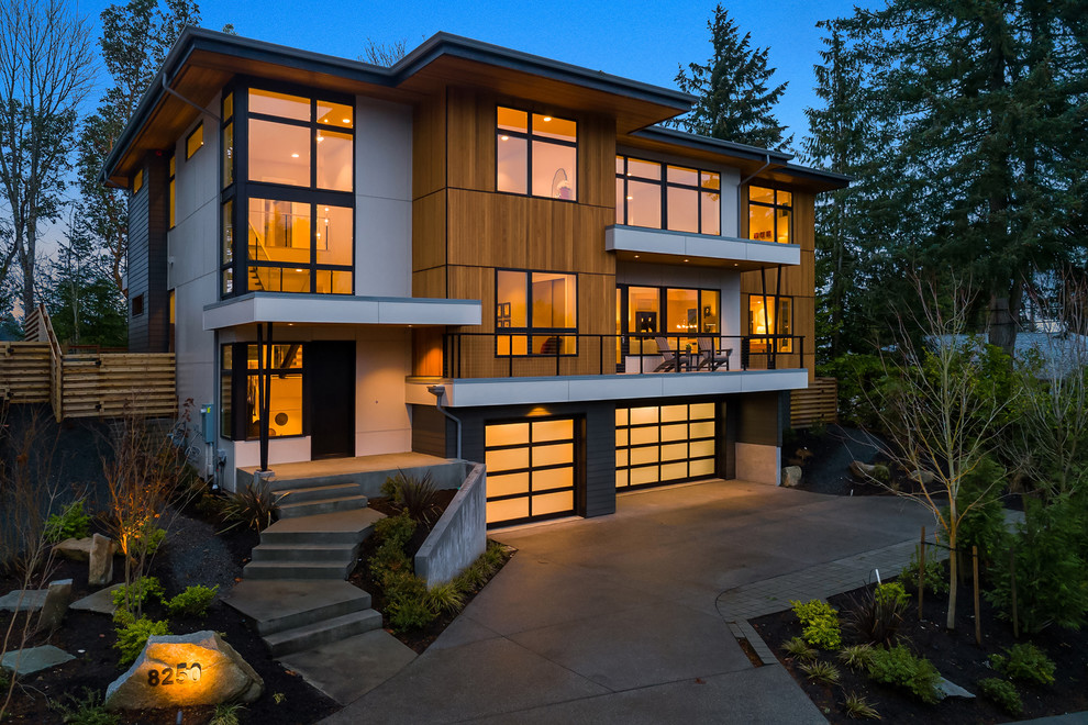 Inspiration for a contemporary three-storey brown house exterior in Seattle with mixed siding and a flat roof.