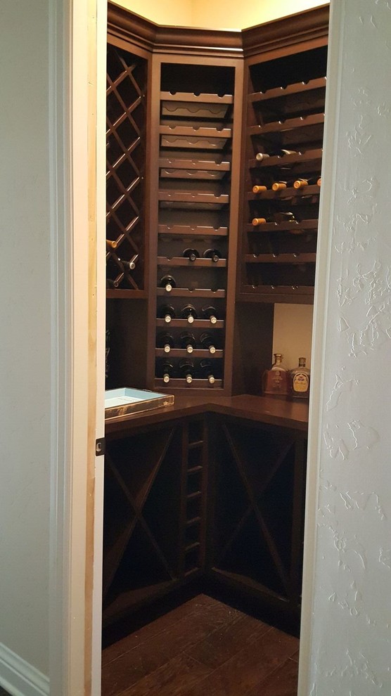Photo of a small traditional wine cellar in Las Vegas with dark hardwood floors and diamond bins.
