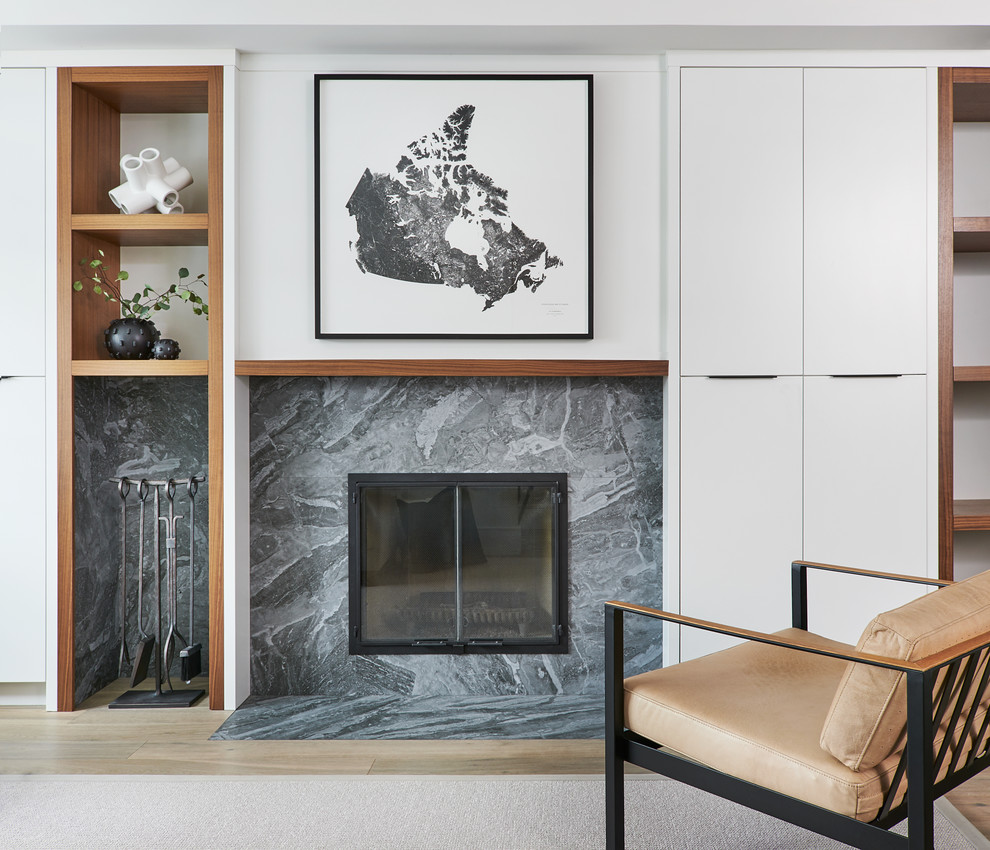 Design ideas for a mid-sized scandinavian enclosed family room in Toronto with a standard fireplace and a tile fireplace surround.