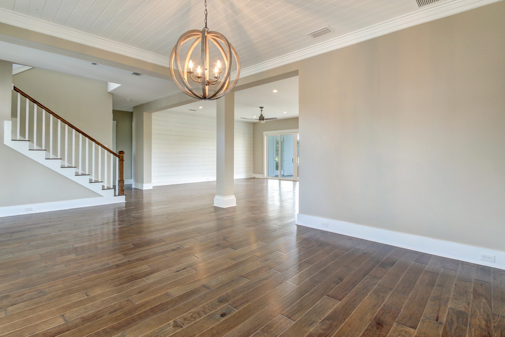 Design ideas for a mid-sized beach style foyer in Jacksonville with beige walls, medium hardwood floors and brown floor.