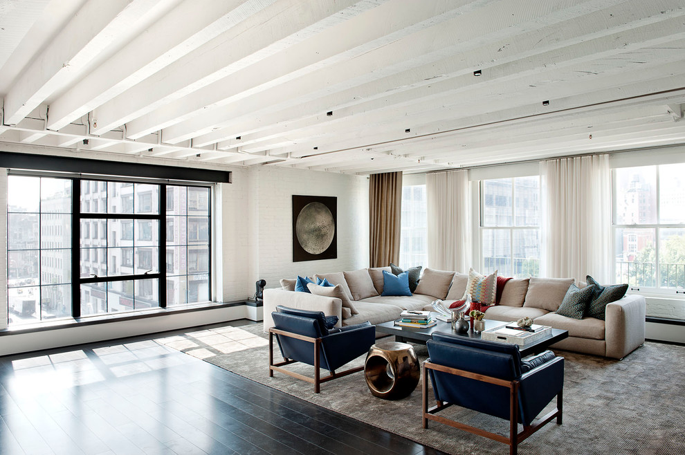 Inspiration for an industrial open concept living room in New York with white walls.