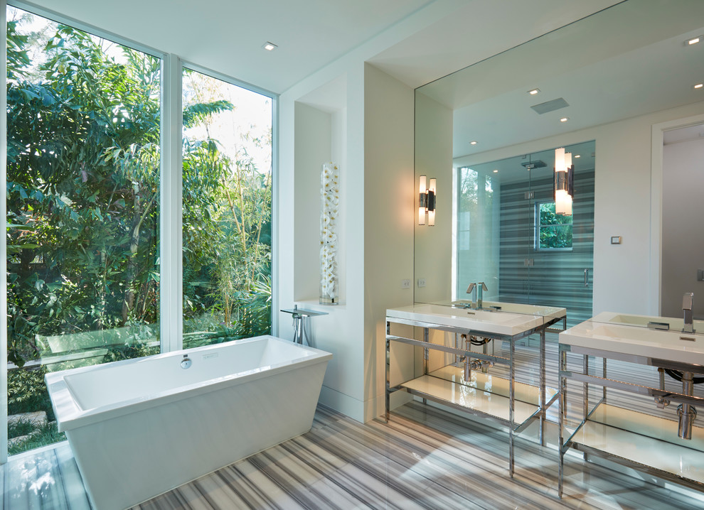 Large contemporary master bathroom in Miami with a freestanding tub, an alcove shower and a console sink.