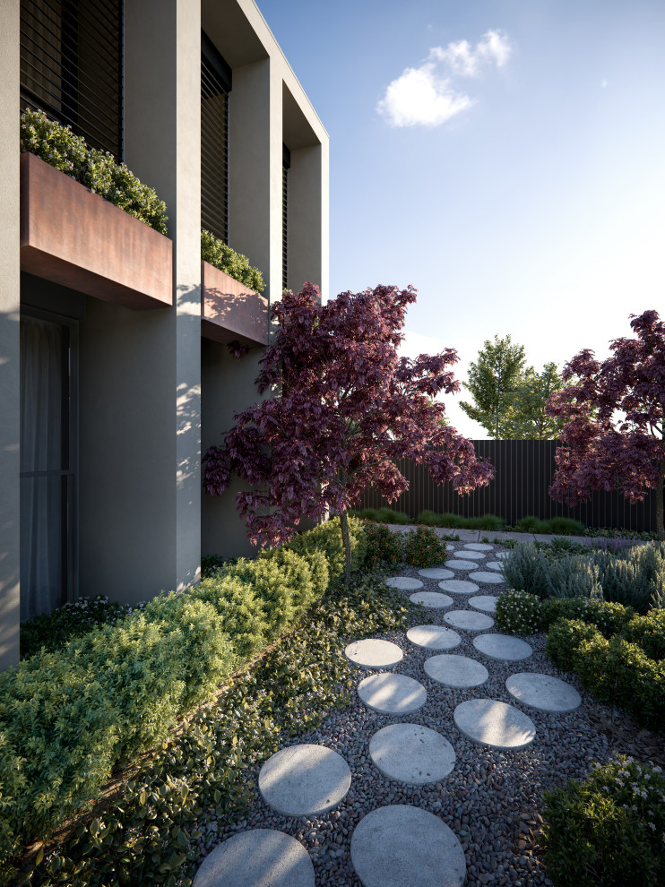 This is an example of a medium sized contemporary front formal full sun garden in Melbourne with a garden path, concrete paving and a wood fence.