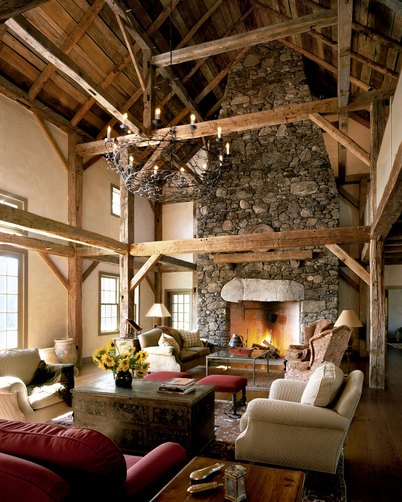 Family room - huge country medium tone wood floor family room idea in New York with white walls, a standard fireplace, a stone fireplace and no tv