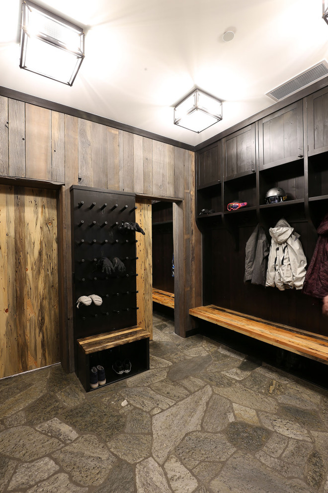 Inspiration for a large rustic gray floor mudroom remodel with a dark wood front door