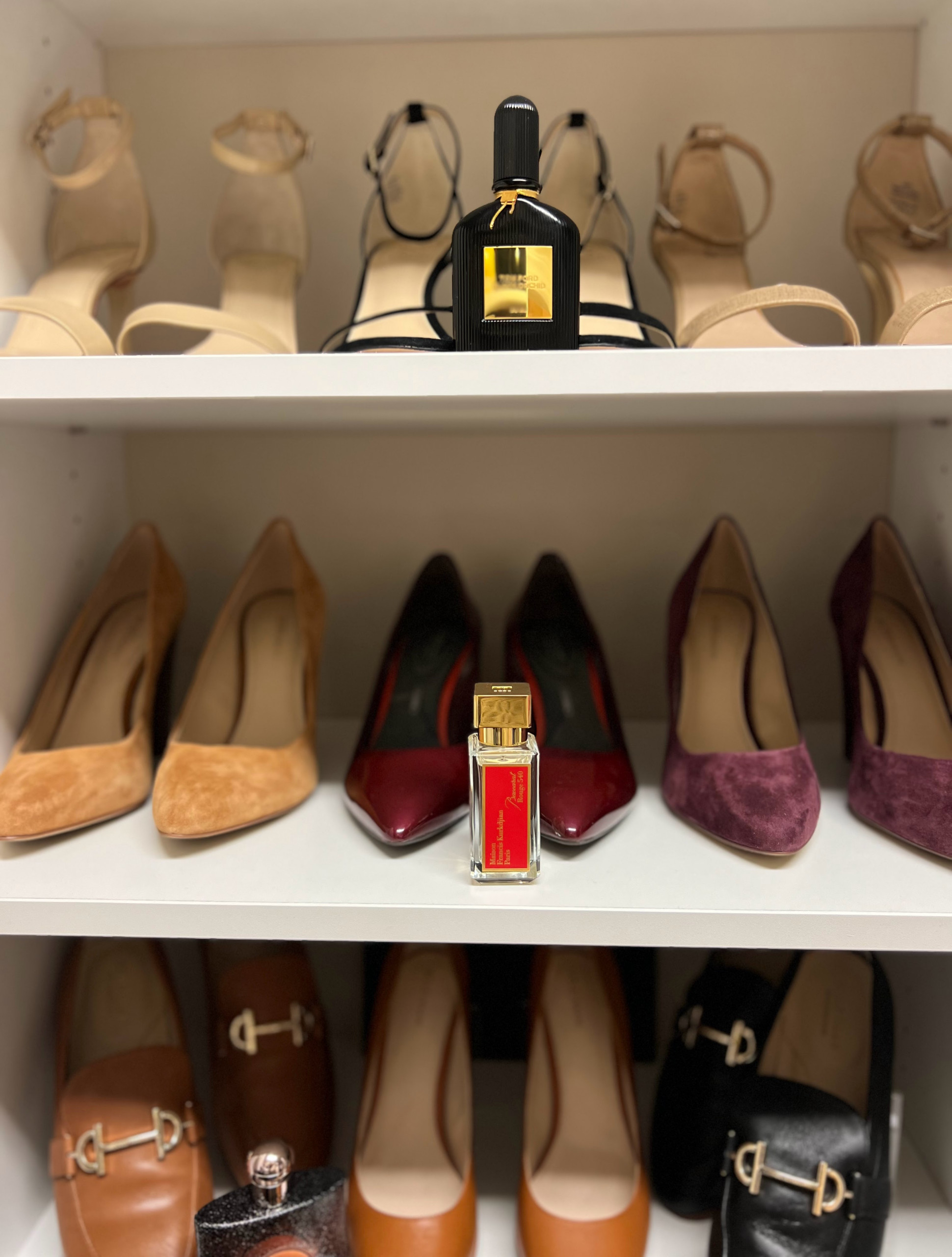 Organized shoe wall with perfumes.
