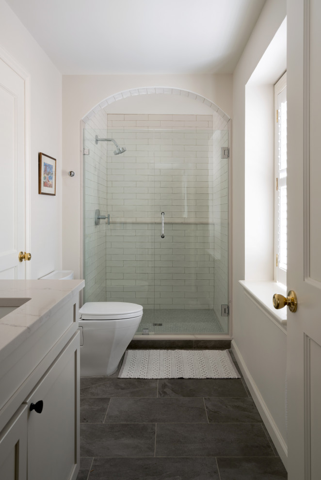 Mid-sized traditional bathroom in Philadelphia with shaker cabinets, grey cabinets, white tile, marble, grey walls, ceramic floors, a console sink, quartzite benchtops, grey floor, a hinged shower door, white benchtops, a single vanity and a built-in vanity.