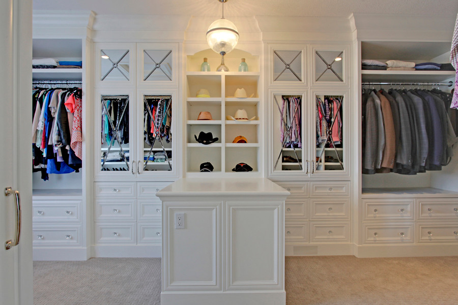 This is an example of a large transitional gender-neutral dressing room in Calgary with recessed-panel cabinets, white cabinets and carpet.