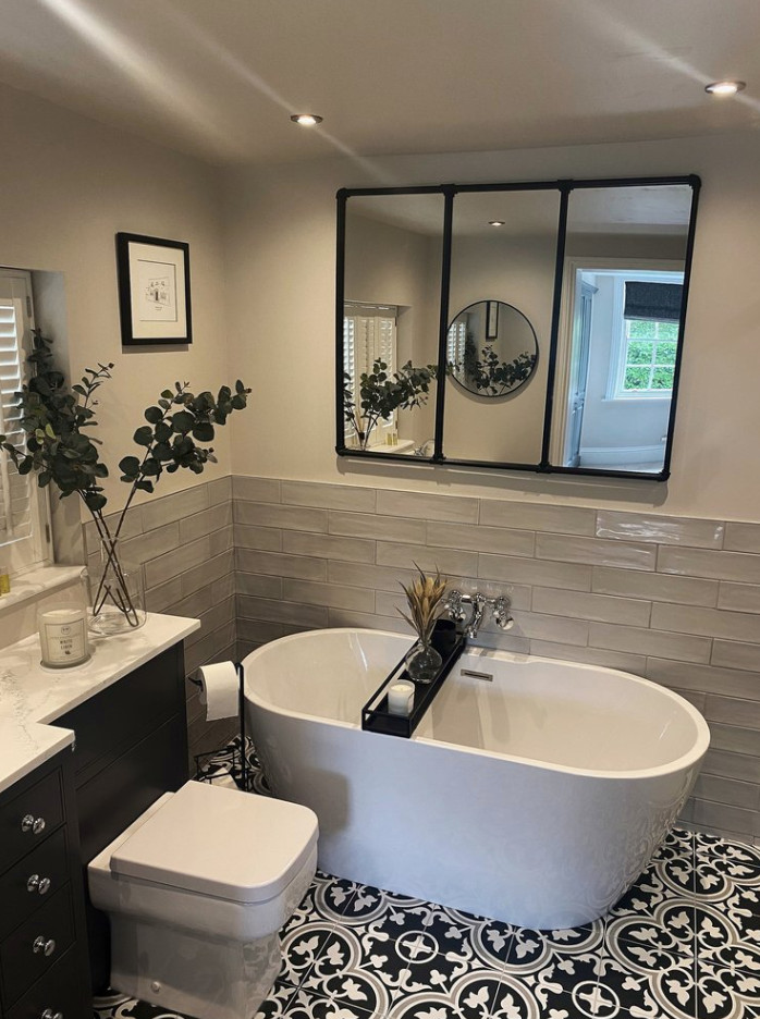 Photo of a small transitional master bathroom in Berkshire with flat-panel cabinets, a built-in vanity, blue cabinets, a freestanding tub, a one-piece toilet, gray tile, ceramic tile, beige walls, cement tiles, a drop-in sink, marble benchtops, multi-coloured floor, white benchtops and a single vanity.