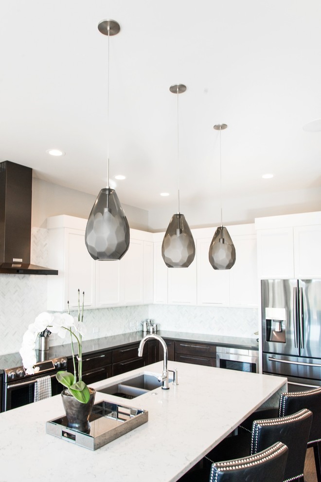 Inspiration for a large transitional l-shaped dark wood floor enclosed kitchen remodel in Orange County with an undermount sink, shaker cabinets, white cabinets, quartz countertops, white backsplash, mosaic tile backsplash, stainless steel appliances and an island