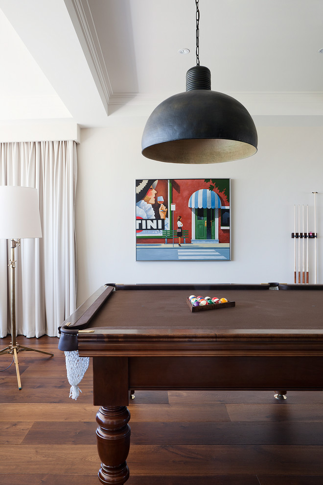 Inspiration for a traditional family room in Melbourne with a game room, white walls and medium hardwood floors.