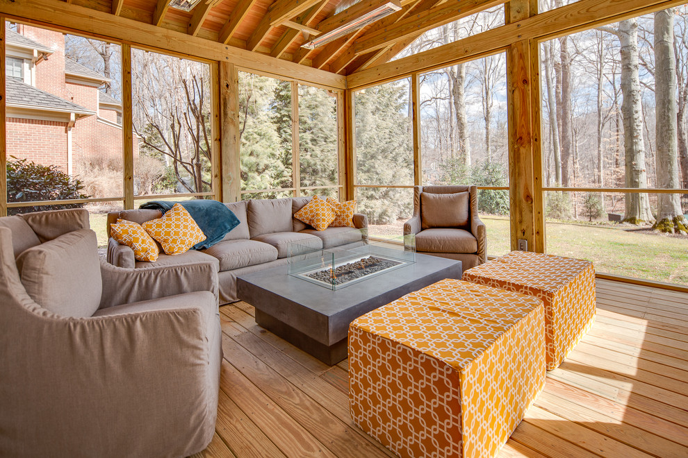 Expansive contemporary backyard screened-in verandah in DC Metro with decking and a roof extension.