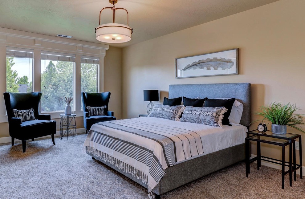 Design ideas for a large eclectic master bedroom in Boise with beige walls and carpet.