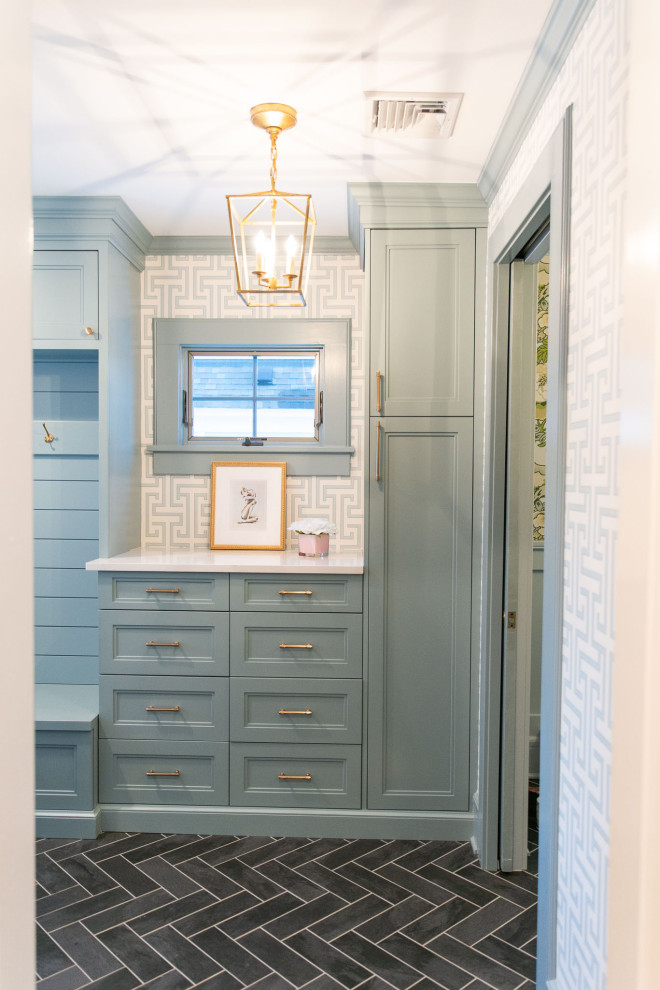 This is an example of a medium sized classic boot room in New York with blue walls, ceramic flooring, a single front door, a blue front door, grey floors and wallpapered walls.