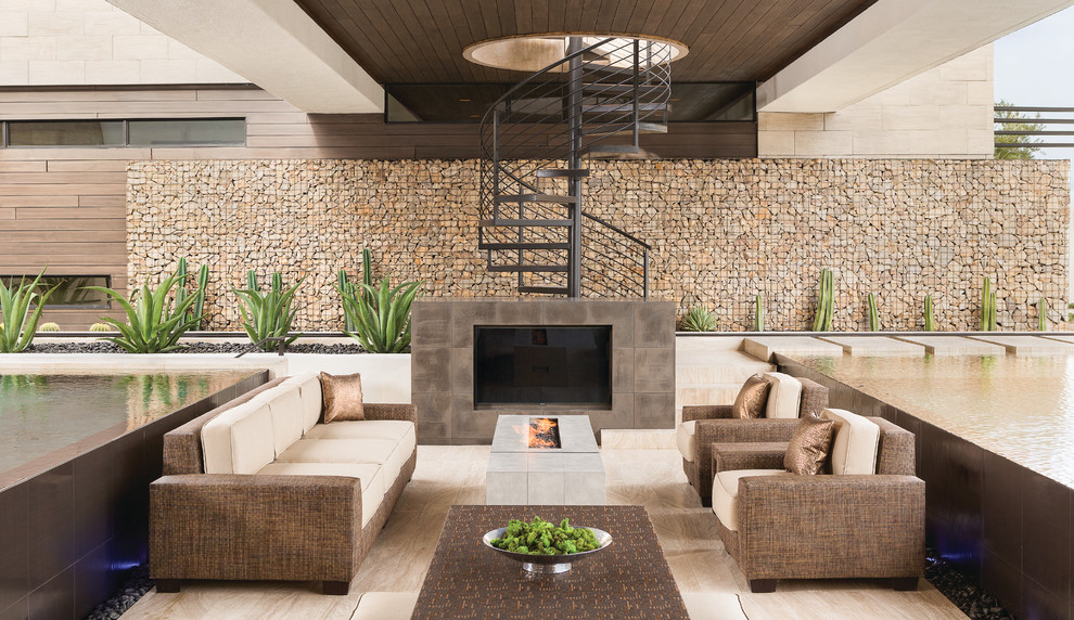 Design ideas for an expansive contemporary backyard patio in Las Vegas with a roof extension.