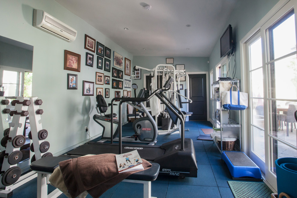 This is an example of a mid-sized mediterranean multipurpose gym in Los Angeles with green walls and blue floor.