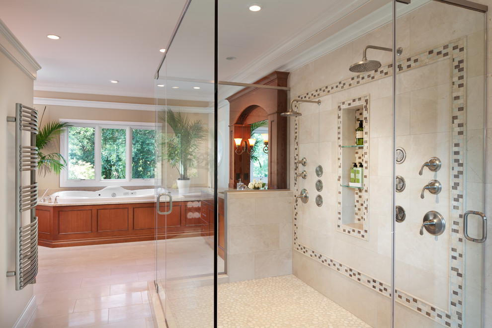 This is an example of a traditional bathroom in DC Metro with recessed-panel cabinets, medium wood cabinets, a drop-in tub, a double shower and beige tile.