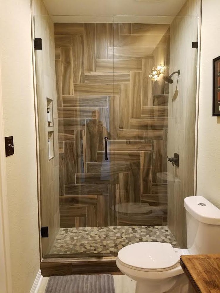 Alcove shower - mid-sized transitional 3/4 brown tile and porcelain tile laminate floor and beige floor alcove shower idea in Austin with furniture-like cabinets, dark wood cabinets, a two-piece toilet, beige walls, a vessel sink and wood countertops