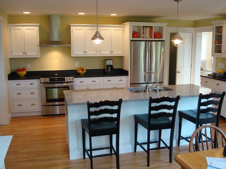 Inspiration for a mid-sized transitional galley eat-in kitchen remodel with an undermount sink, shaker cabinets, white cabinets, granite countertops, stainless steel appliances, an island and black countertops
