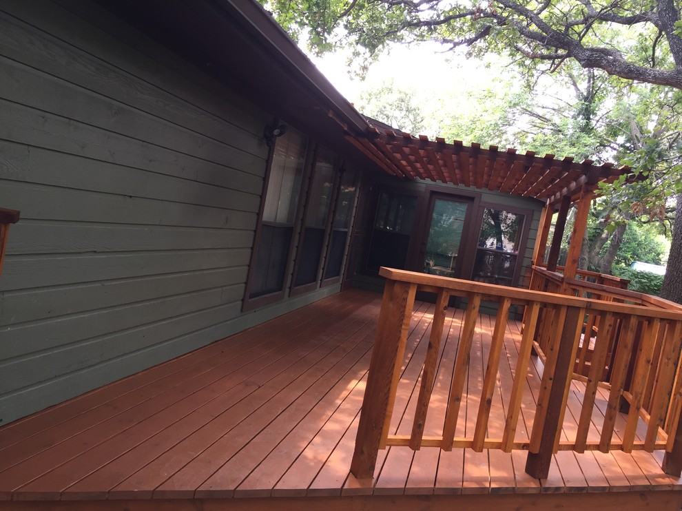 Mid-sized arts and crafts backyard deck in Dallas with a pergola.