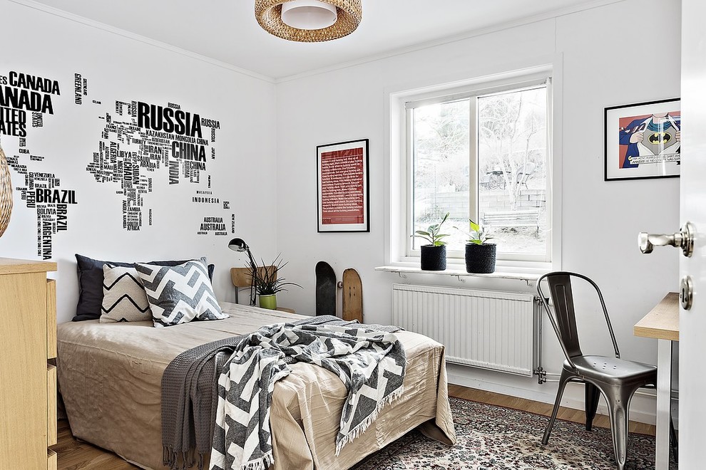 Mid-sized scandinavian kids' room in Gothenburg with white walls and light hardwood floors for boys.