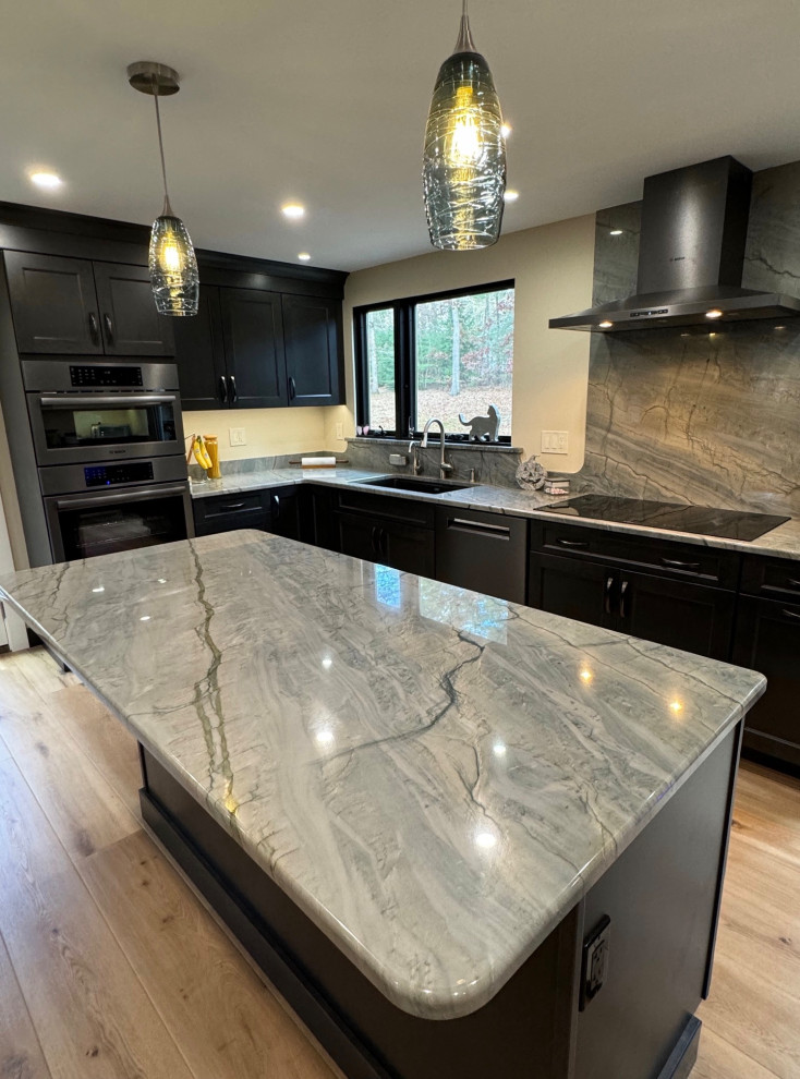 Mid-sized transitional u-shaped laminate floor and brown floor eat-in kitchen photo in Boston with an undermount sink, shaker cabinets, brown cabinets, quartz countertops, black appliances, an island and multicolored countertops