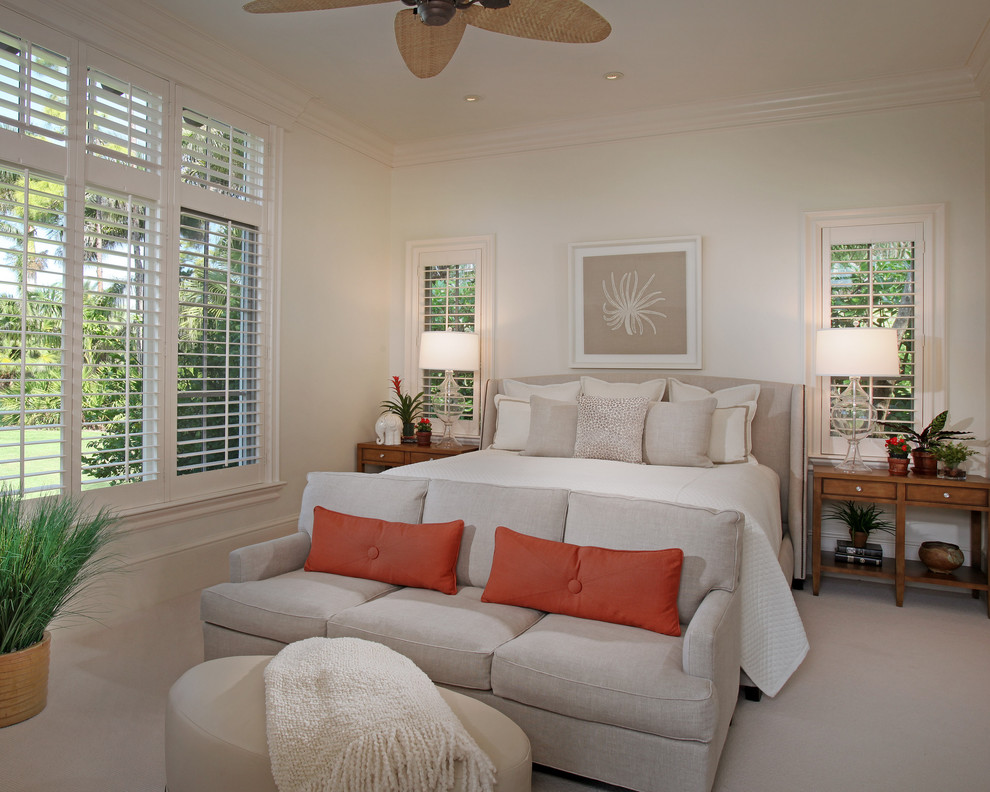 Inspiration for a mid-sized tropical master bedroom in Miami with white walls and carpet.