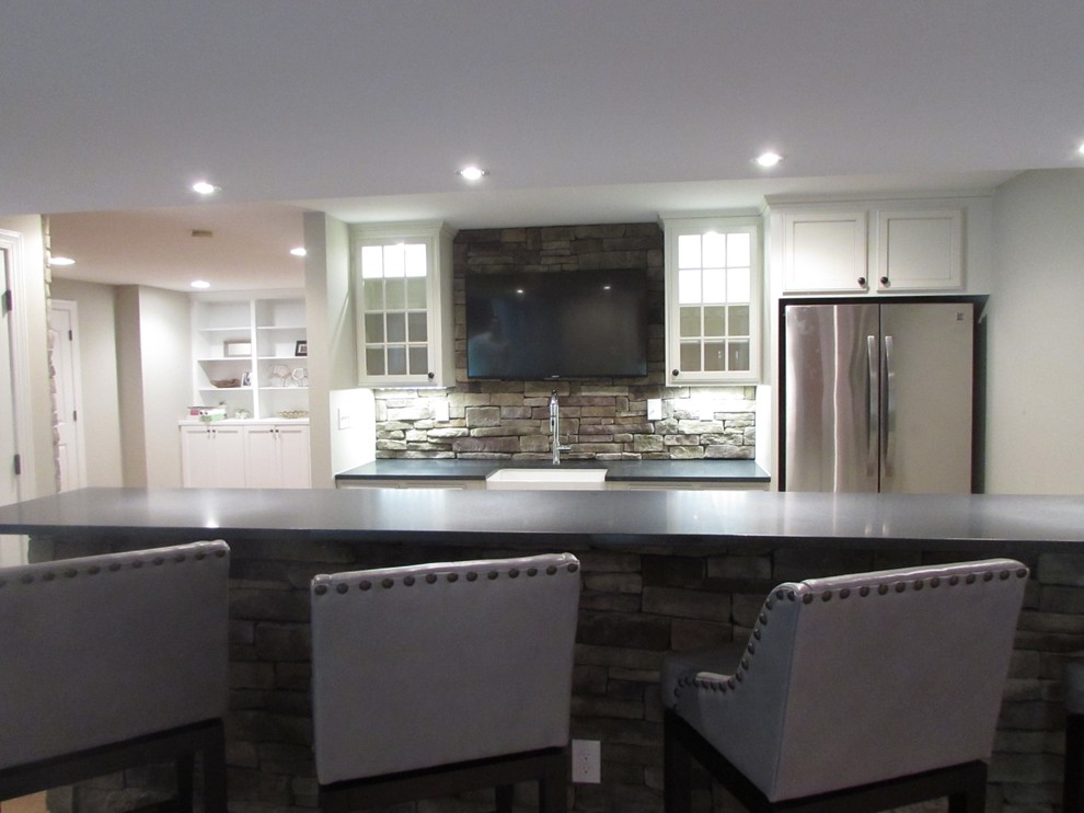 Basement - large walk-out vinyl floor basement idea with beige walls, a standard fireplace and a stone fireplace