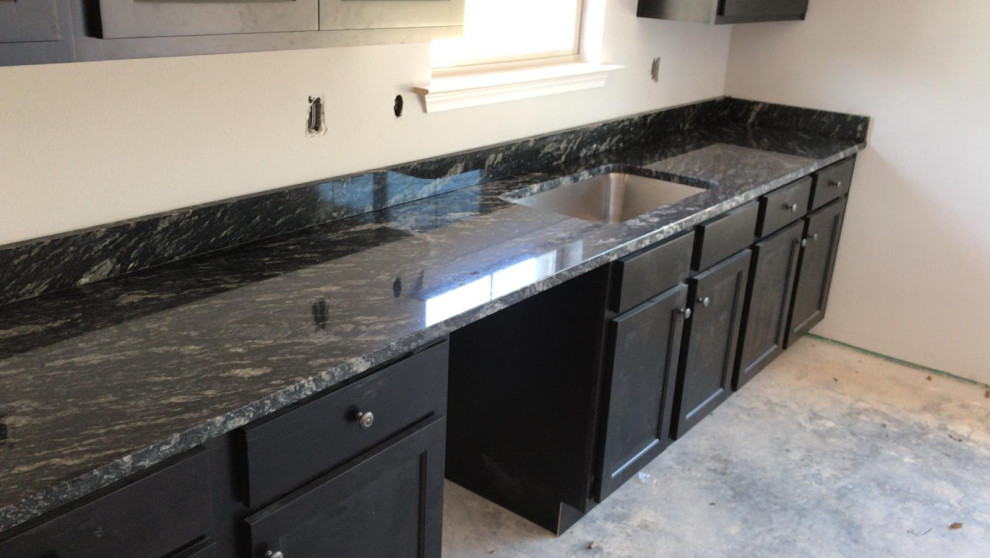 Inspiration for a mid-sized kitchen remodel with black cabinets, granite countertops, stainless steel appliances and black countertops