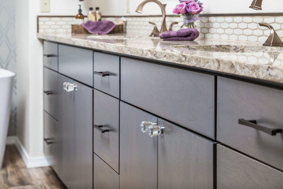 Inspiration for a mid-sized transitional master beige tile and ceramic tile vinyl floor freestanding bathtub remodel with flat-panel cabinets, dark wood cabinets, a two-piece toilet, beige walls, an undermount sink and quartz countertops