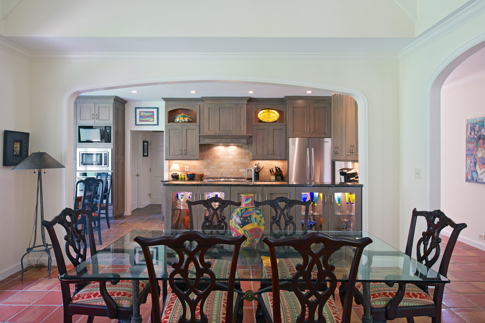 Example of a large classic u-shaped ceramic tile open concept kitchen design with an undermount sink, beaded inset cabinets, gray cabinets, granite countertops, beige backsplash, travertine backsplash, stainless steel appliances and a peninsula